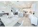 Bright, open-concept kitchen with white cabinets, large island, modern appliances, and adjacent dining area at 19836 Bridgetown Loop, Venice, FL 34293