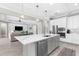 Modern kitchen with marble countertops, a large island, stainless steel appliances, and pendant lighting at 19836 Bridgetown Loop, Venice, FL 34293