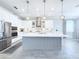 Bright, eat-in kitchen boasts stainless steel appliances, pendant lighting, and a large center island at 19836 Bridgetown Loop, Venice, FL 34293