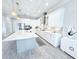 Kitchen with stainless steel appliances, stylish pendant lighting, and a large center island at 19836 Bridgetown Loop, Venice, FL 34293
