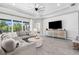 Spacious living room with coffered ceiling, modern furnishings, and a large window overlooking the yard at 19836 Bridgetown Loop, Venice, FL 34293