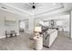 Living room leading to kitchen featuring comfortable seating, stylish decor, and open concept design at 19836 Bridgetown Loop, Venice, FL 34293