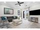 Comfortable living room with a large sectional sofa, modern lighting, and access to the outdoor space at 19836 Bridgetown Loop, Venice, FL 34293