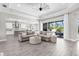 Open-plan living room and kitchen, featuring a large sectional sofa and tile flooring at 19836 Bridgetown Loop, Venice, FL 34293