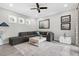 Cozy living room with neutral decor, a ceiling fan, and ample natural light at 19836 Bridgetown Loop, Venice, FL 34293