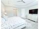 Relaxing main bedroom with tray ceiling, plenty of natural light, and an ensuite bathroom at 19836 Bridgetown Loop, Venice, FL 34293