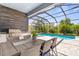 Screened-in patio with an outdoor kitchen and dining area, overlooking a private pool at 19836 Bridgetown Loop, Venice, FL 34293