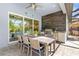 Entertaining outdoor kitchen with modern appliances, a spacious table and sleek tile flooring at 19836 Bridgetown Loop, Venice, FL 34293
