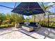 Relaxing screened outdoor living space featuring comfortable lounge seating and a cozy fire pit at 19836 Bridgetown Loop, Venice, FL 34293