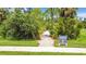 Scenic walking trail surrounded by lush greenery, offering an inviting path to Heron Park at 19836 Bridgetown Loop, Venice, FL 34293