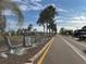 Street view of the community, featuring palm trees and a schedule of events at 242 Blackburn Blvd, North Port, FL 34287