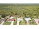 Aerial view of a neighborhood with mature trees and green lawns backing up to a greenbelt at 407 Rubens Dr, Nokomis, FL 34275