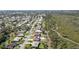 Aerial view of homes along a street, landscaped yards and natural area at 407 Rubens Dr, Nokomis, FL 34275