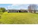 A spacious backyard and sunroom create an inviting outdoor living space with a neutral paint color at 407 Rubens Dr, Nokomis, FL 34275
