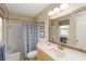 Cozy bathroom with shower and tub, framed mirror, and soft lightning at 407 Rubens Dr, Nokomis, FL 34275