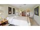 Bright bedroom featuring a queen bed, carpet flooring, and access to closet at 407 Rubens Dr, Nokomis, FL 34275