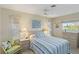 Cozy bedroom featuring nautical decor, soft lighting, and a comfortable queen size bed at 407 Rubens Dr, Nokomis, FL 34275