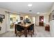 Dining room features a stylish table, comfortable seating, and access to the lanai at 407 Rubens Dr, Nokomis, FL 34275