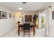 Inviting dining room with natural light and access to the lanai at 407 Rubens Dr, Nokomis, FL 34275