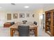 Traditional dining room with marble table, neutral walls, artwork, and wooden bookshelf at 407 Rubens Dr, Nokomis, FL 34275