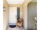 Close up of front door entrance with a chair and welcome mat at 407 Rubens Dr, Nokomis, FL 34275