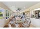 Spacious sunroom with rattan furniture, tile floors, and large windows with a sun-filled atmosphere at 407 Rubens Dr, Nokomis, FL 34275
