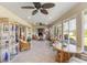 Bright sunroom featuring ceiling fans, tile flooring, and expansive windows offering outdoor views at 407 Rubens Dr, Nokomis, FL 34275