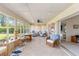 Bright sunroom with a ceiling fan, tile floors, lots of windows, and wicker furniture at 407 Rubens Dr, Nokomis, FL 34275