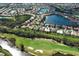 Aerial view of the property and surrounding community with golf course and water features at 408 Otter Creek Dr, Venice, FL 34292
