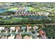 Aerial view of the property and surrounding community featuring water views and golf course at 408 Otter Creek Dr, Venice, FL 34292