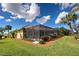 Manicured backyard featuring pool in screened lanai, landscaping and mature trees at 408 Otter Creek Dr, Venice, FL 34292