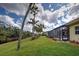 Backyard view featuring pool in screened enclosure, lush lawn, landscaping and mature trees at 408 Otter Creek Dr, Venice, FL 34292