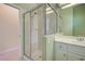 Modern bathroom featuring a glass-enclosed shower with tile surround and a vanity with white cabinets at 408 Otter Creek Dr, Venice, FL 34292