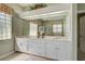 Bathroom with a large mirror, granite countertop, double sinks, and ample storage space at 408 Otter Creek Dr, Venice, FL 34292