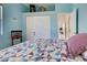Bedroom with a blue wall, quilt-covered bed, closet and access to another room at 408 Otter Creek Dr, Venice, FL 34292