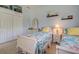 Bright bedroom features twin beds with nautical themed bedding, closet, and storage at 408 Otter Creek Dr, Venice, FL 34292