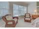 Relaxing bedroom sitting area with wicker chairs and plenty of natural light at 408 Otter Creek Dr, Venice, FL 34292