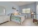 Bright bedroom features twin beds with nautical themed bedding and a large window at 408 Otter Creek Dr, Venice, FL 34292