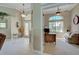 Inviting home foyer leading to an office with a large arched window and a ceiling fan at 408 Otter Creek Dr, Venice, FL 34292