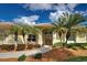 Close up of the front entrance, showcasing the doors, stone accents and mature landscaping at 408 Otter Creek Dr, Venice, FL 34292