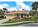 Charming one-story house featuring lush landscaping, a tile roof and a two-car garage at 408 Otter Creek Dr, Venice, FL 34292
