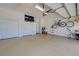 Organized garage with storage closets, utility sink, and space for bikes and exercise equipment at 408 Otter Creek Dr, Venice, FL 34292