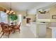 Bright kitchen and dining area featuring tile floors and a center island with white cabinets at 408 Otter Creek Dr, Venice, FL 34292