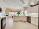 Bright kitchen with white cabinetry, stainless appliances, and tile floors at 408 Otter Creek Dr, Venice, FL 34292