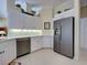 Kitchen featuring stainless refrigerator and white cabinets at 408 Otter Creek Dr, Venice, FL 34292