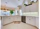 Bright kitchen with white cabinetry, stainless appliances, and tile floors at 408 Otter Creek Dr, Venice, FL 34292