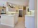 Open kitchen with stainless refrigerator and white cabinets at 408 Otter Creek Dr, Venice, FL 34292