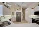 Open kitchen with stainless refrigerator and white cabinets at 408 Otter Creek Dr, Venice, FL 34292