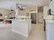 Open kitchen with stainless refrigerator and white cabinets at 408 Otter Creek Dr, Venice, FL 34292
