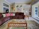 Spacious living room with a comfortable couch, glass coffee table, and access to other living areas at 408 Otter Creek Dr, Venice, FL 34292